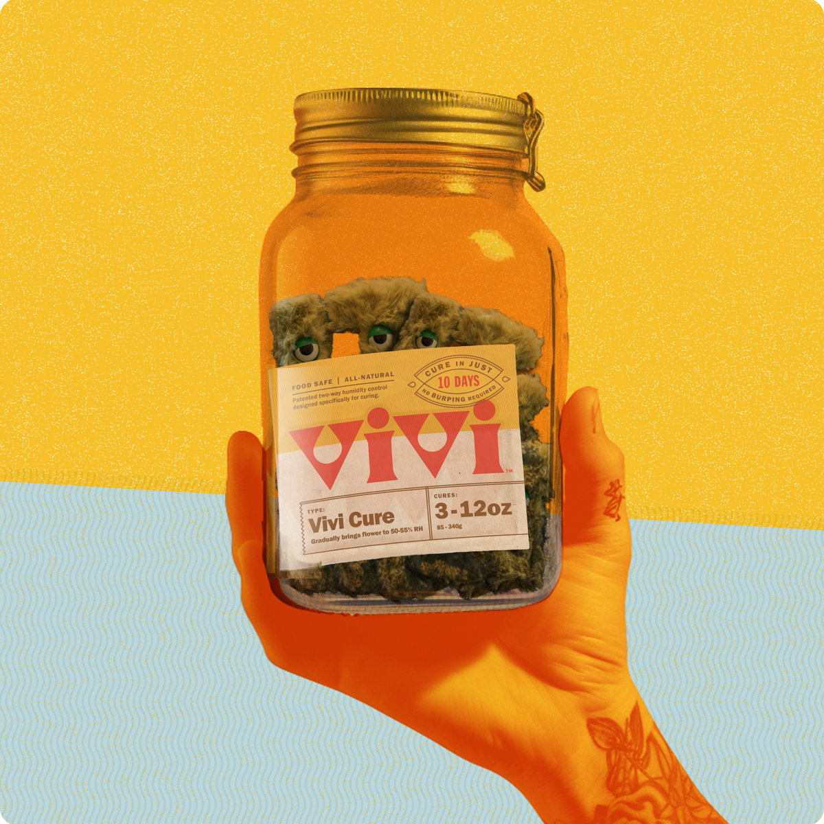 A persons hand holding a glass jar aloft. The jar has a Vivi Curpack inside. A persons hand holding a glass jar aloft. The jar has a Vivi Curpack inside.